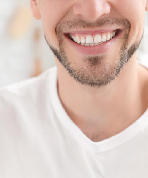 A man smiles after taking dental services from a dentist near me A man smiles after taking dental services from a dentist near me