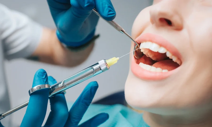 A Dentist applying local anesthesia to the gums