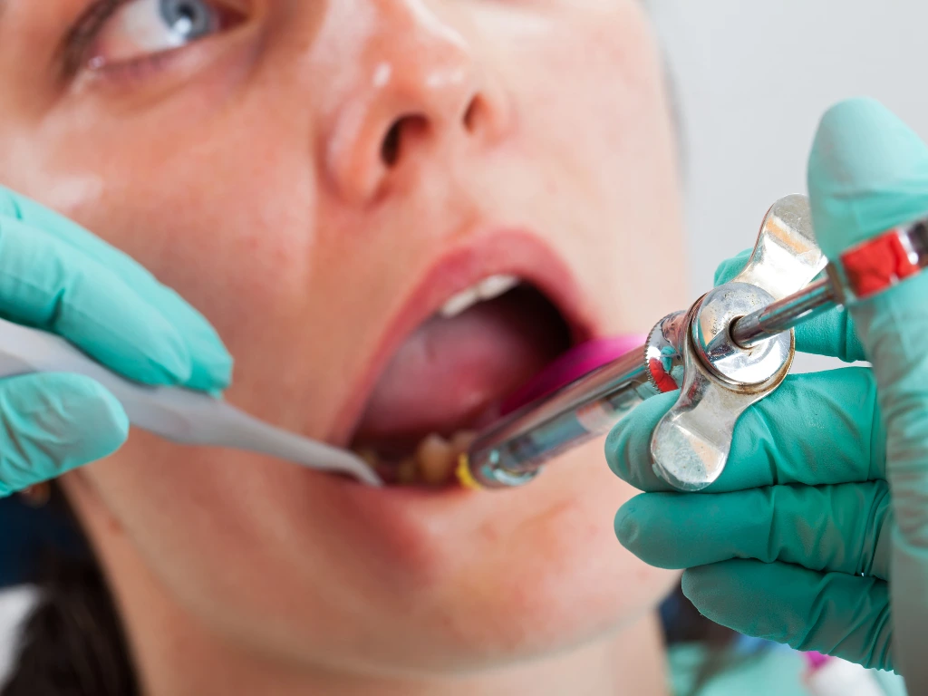 A Dentist applying local anesthesia to a patient