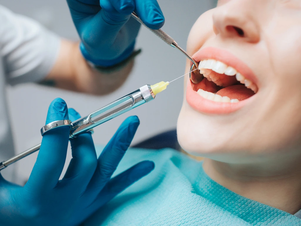 A Dentist applying local anesthesia to the gums